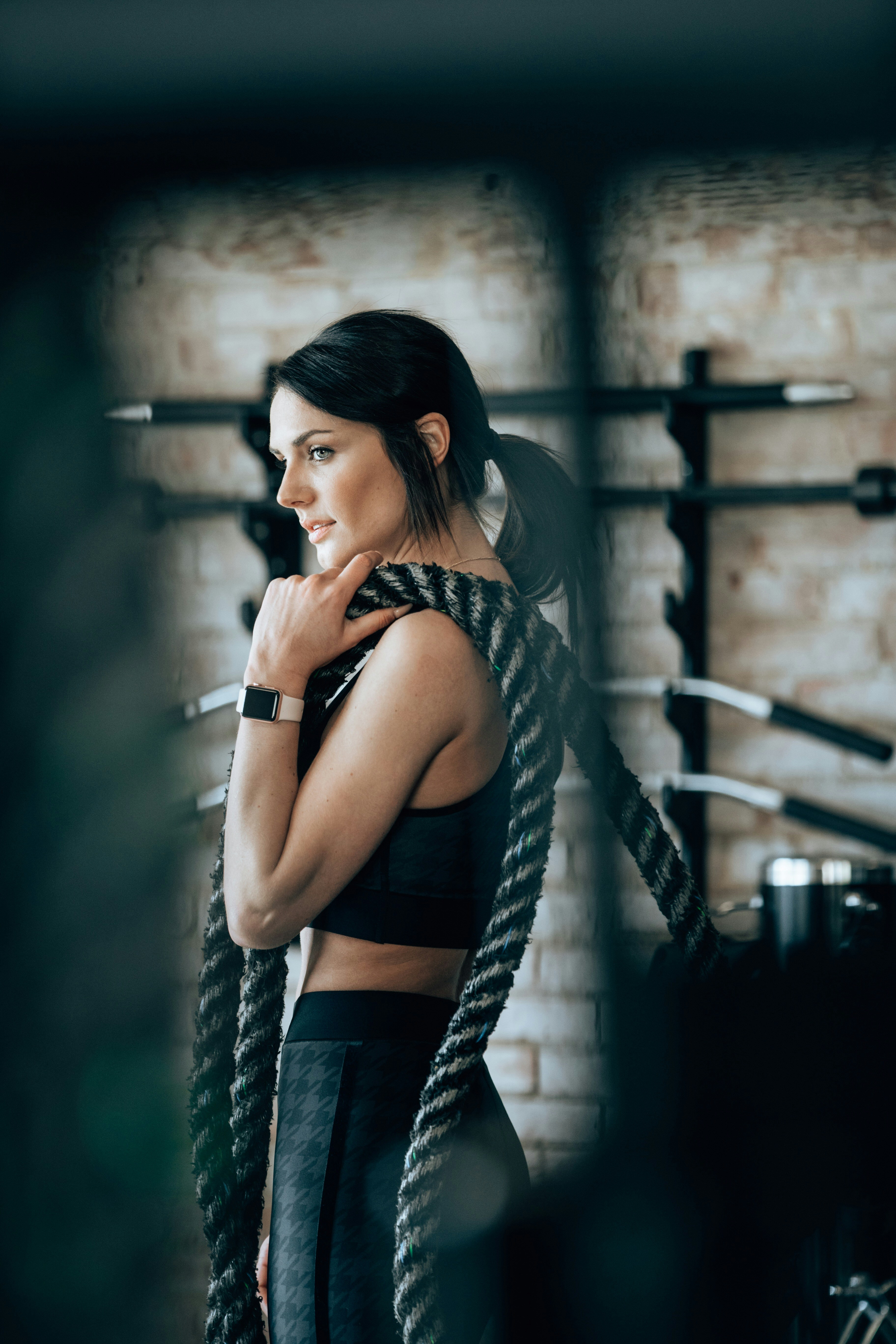 Woman training with battle ropes in a gym